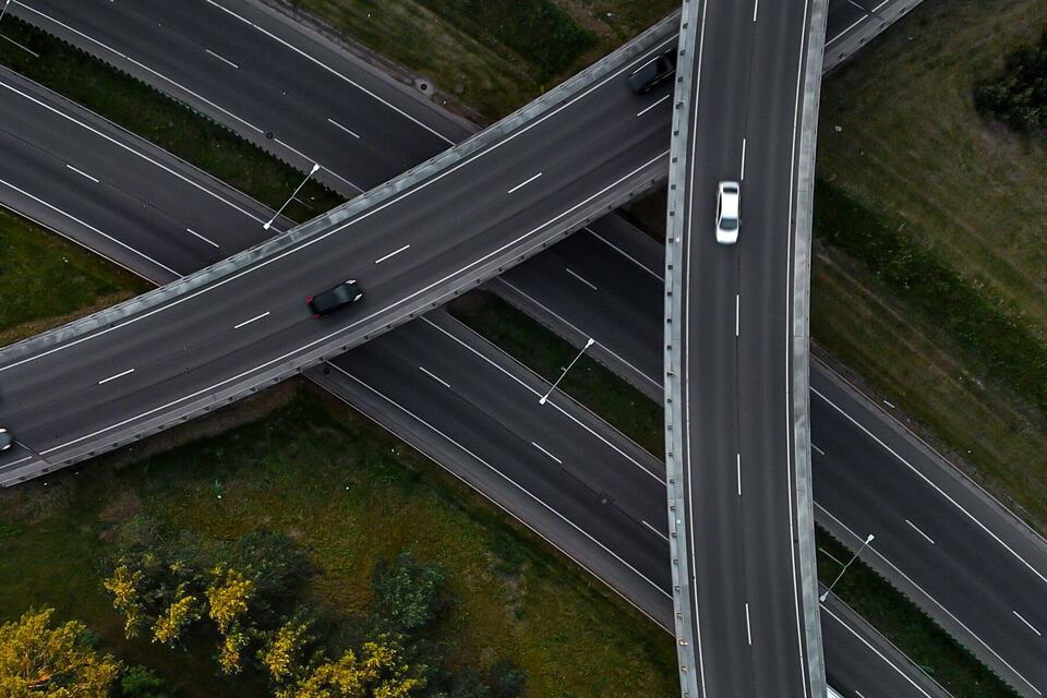 Top-down aerial view of highway overpasses crossing over each other